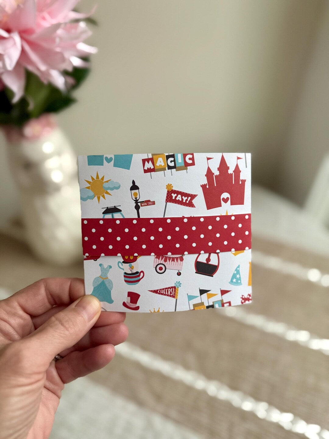 Folded tri-fold handmade birthday card with red polka-dot belly band, castle and 'Magic' illustration