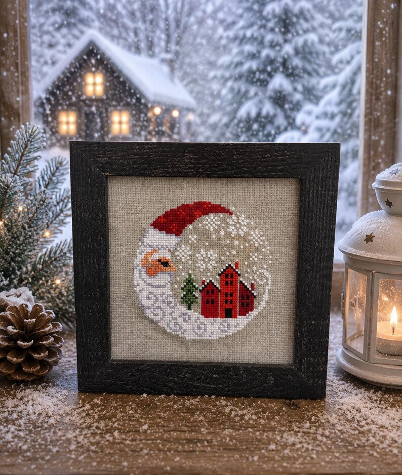Framed cross-stitch — Santa Christmas Village, dark brown frame close-up