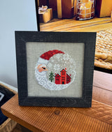 Framed cross-stitch — Santa Christmas Village, distressed black frame