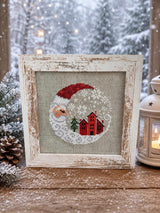 Framed cross-stitch — Santa Christmas Village, distressed white frame