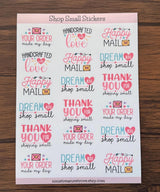 Flat-lay of the Happy Mail thank-you sticker sheet on a wooden surface, showing 18 hand-illustrated small-business stickers