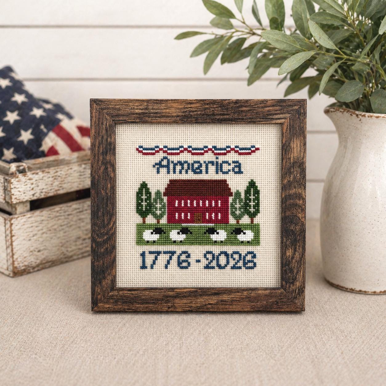 Hand-stitched America cross-stitch — framed, red barn with sheep